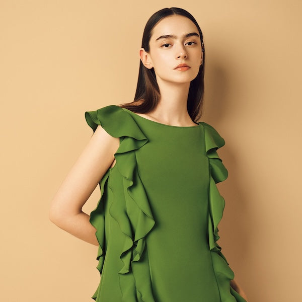 Model is wearing a green dress.