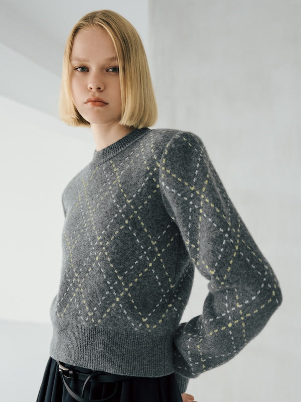 The model is wearing a grey patterned sweater.